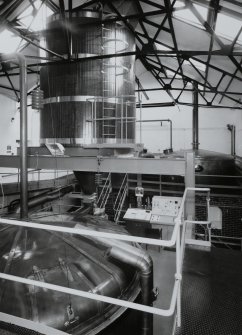 Bowmore Distillery
Interior view within mash house showing mash tun (below), grist hopper (above), and copper water tanks in background