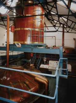 Bowmore Distillery
Interior view within mash house showing mash tun (below), grist hopper (above), and copper water tanks in background