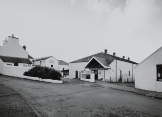 Bowmore Distillery
General view of main entrance to distillery from NE, showing the adjacent indoor Bowmore Swimming Pool (right), which is heated using waste heat from the distillery