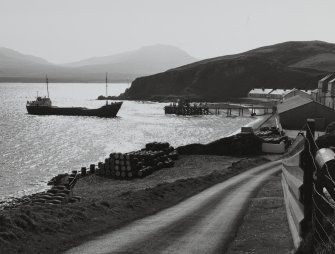 Bunnahabanainn Distillery, Islay.
General view of distillery from North West with grain-ship approaching pier.