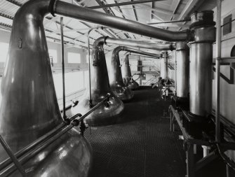 Distillery, Port Ellen.
View of interior of Still House, 'wash' and low-wines (spirit) stills, showing dipped 'lyne-arms' connecting with condensers (far right).