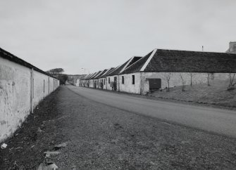 Islay, Port Ellen Distillery
View from E along the Oa road, showing bonded warehouses on either side