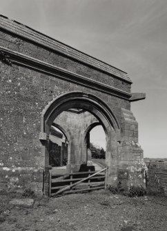 Detail of round arched ashlar porte-cochere