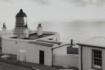 View from NE of lighthouse and associated buildings, with top of foghorn also visible (centre right)