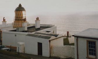 View from NE of lighthouse and associated buildings, with top of foghorn also visible (centre right)