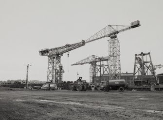 General view from NE of cranes, with giant cantilever crane (left), built by Sir William Arrol & Co in 1907.  150-ton capacity, uprated to 200-tons in 1937.  Photosurvey 19-FEB-1991