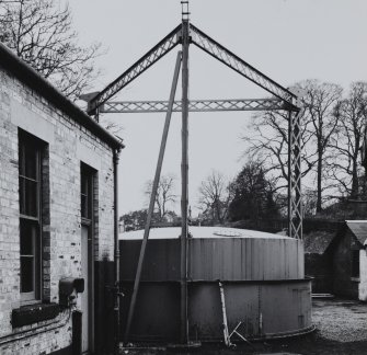 View of gasholder with triform latticed hoisting posts.
