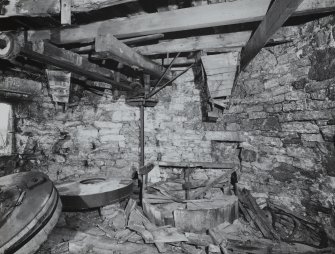 Interior.
View of first floor, upright shaft and mill stones from West.