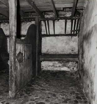 Interior.
Detail of stall and hay heck in stable.