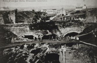 Photograph of postcard of ironworks from embankment