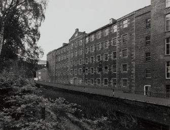 General view across the lade from N of the NE side of Mill No.3