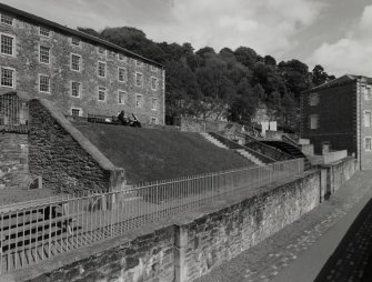 General view of the foundations and water-wheel pit of Mill No.4, which was destroyed by a fire in 1883.  The Institute can be seen to the left, and part of the School to the right