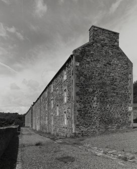 General view from S along SW side of Wee Row, with SE gable end in foreground (right), and 9-24 Double Row in background (left)