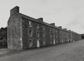 General view from ENE of NE side of Wee Row, which has been converted into a Youth Hostel.  9-24 Double Row can also be seen (right)
