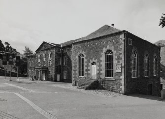 View from N of NE and NW sides of the engine house, which is detached from the mill itself (background right), being situated at the NW end of 'The Institute'.  Mill No.3 and its engine house are now connected by an overhead walkway