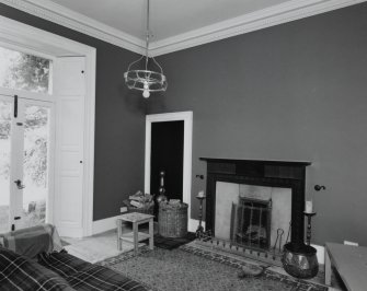 Interior, view of sitting room showing Jansen designed mahogany fireplace