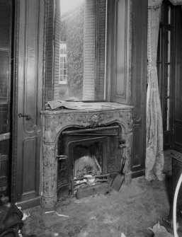 Interior, morning room, detail of Jansen designed fireplace set beneath a window and panneling