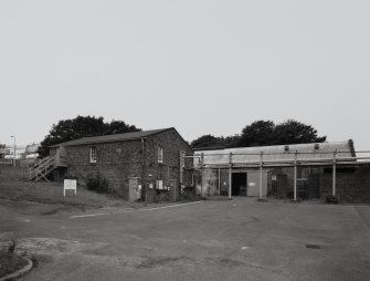 General exterior view from E of Ammonia Cooling Plant House (right, AJ1, NS 2867 3991) 
and Glycerine Storage building (left, AJ2, NS 2868 3991)