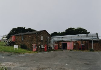 General interior view from E of Ammonia Cooling Plant House (right, AJ1, NS 2867 3991) and Glycerine Storage building (left, AJ2, NS 2868 3991)	