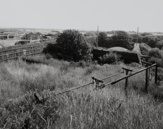 Elevated general view from SW looking towards 'C' house AC2 (NS 2876 3983), showing a landscape dominated by Chilworth Mounds, lightning conductors, gutters and pipework