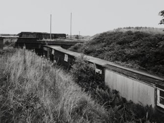 Elevated exterior view from SW of mixing house PZ1, (a Nitroglycerine/ Nitrocellulose Mixing House (NS 2885 3984)), showing covered gangway leading from NG separation and storage house, AC2 (NS 2876 3983)