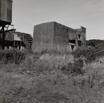 View from S of one of two shells of cartrdidge houses, at the SE end of range of four complete units (AZF1-4). The concrete shells [NS 2864 3966] were built in reserve, and could have been made up into cimplete units (including the construction of Chilworth Mounds to protect the concrete shell) if required.