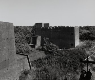 Elevated view from W of one of two shells of Cartridging Houses, at the SE end of four complete units (AF1 - 4). The crenelated concrete shells [NS 2864 3966] were built in reserve and could have been made up into complete units (including the construction of Chilworth Mounds to protect the concrete shell) if required