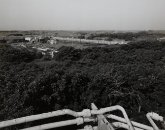 Elevated view from Nitroglycerine Hill No. 2 (NE, NS23NE 1.03] of building AZ1 [NS 2849 3975] and ropeway gantry connecting Catridging Houses (AZF1 - 4) and non-explosive Mixing House complex (AY1, AY2 and AE1 [NS 2850 3990]) to right