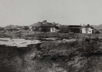 Photographic copy of a general view showing the dynamite cartridging huts, with Nitro-glycerine Hill behind (probably pre-1880)