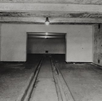 Photographic copy of Interior view of a large Magazine, showing centrally located tramway used to bring explosives in and out of the building (not dated).  Note also the intrinsically safe lighting.