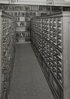 Interior.  View within library showing wooden cabinets containing drawers of index cards, cross-referencing Reports with reference books,journals and other records