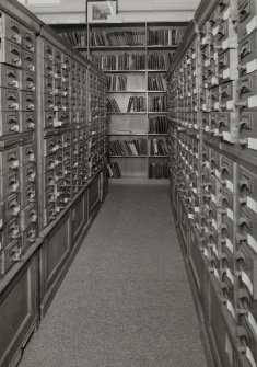 Interior.  Detailed view within library showing wooden cabinets containing drawers of index cards, cross-referencing Reports with reference books,journals and other records