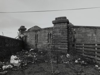 View of walls forming SW corner from E