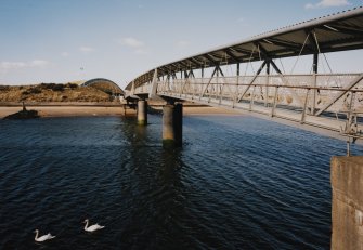 Oblique view from S along SW side of the bridge, with 'The Bid Idea' visible in the background