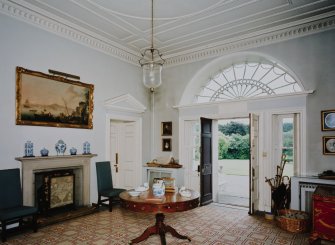 Interior.View of entrance hall from NW showing fireplace and entrance door
