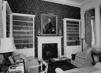 Interior. View of ground floor library from SSW showing fireplace and bookcases