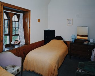 Interior. first floor View of a W bedroom from S with corner fireplace