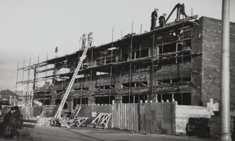 Copy of historic photograph showing view from SW of building during construction.