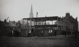 Copy of historic photograph showing view of building during early stages of construction.