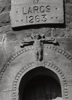 Detail of carving of crucifixion at head of doorway