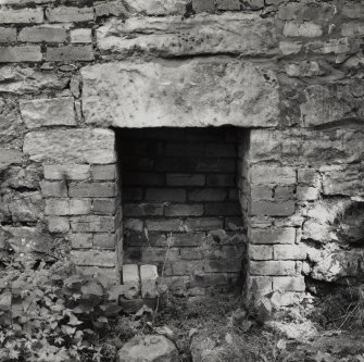 Detail of lower fireplace in S wall.