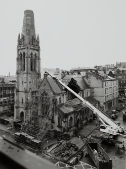 High level general view from SE showing front elevation supported by scaffolding