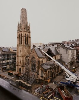 High level general view from SE showing front elevation supported by scaffolding