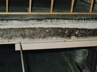Interior. Detail of exposed cast-iron beam in cut-away portion of top floor