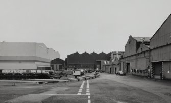 General view from W at S end of fitting-out basin, with former Plumbers' Shops to right, and former engine works beyond, and the new 'Tank Assembly Shop' to the left