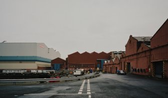 General view from W at S end of fitting-out basin, with former Plumbers' Shops to right, and former engine works beyond, and the new 'Tank Assembly Shop' to the left