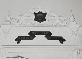 Detail of doorhead scroll in W entrance hall