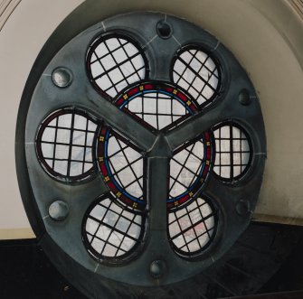 Interior. 
Detail of stained glass in wheel window at gallery level.