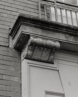 Main E front, above entrance, carved pilaster head, detail