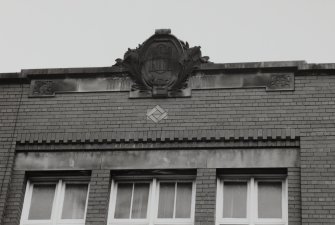 W front, roof level, cartouche containing letters: HSH, detail